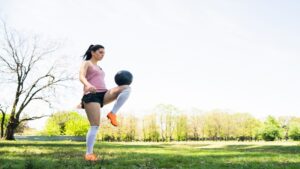 Woman practicing football skills outdoors for how to update etsjavaapp by etruesports